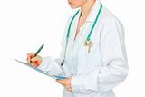 Medical female doctor making notes in document. Close-up.
