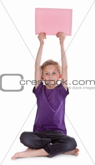 boy sitting and holding a blank page