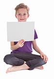 boy sitting and holding a blank white page 