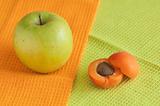 The ripe apricot and green apple
