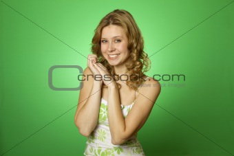 Beautiful young woman on green background