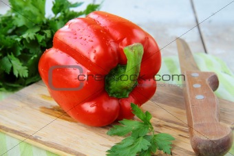 large red bell peppers on a cutting board