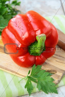 large red bell peppers on a cutting board