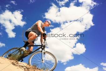 Young men  riding a bike downhill style