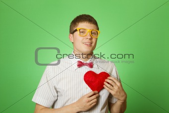 Smiling guy holding heart shape