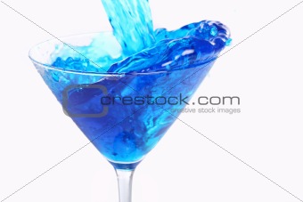 Blue liquid pouring into glass