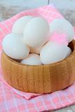 wooden bowl with eggs and feathers rustic style