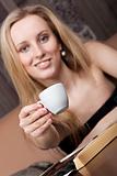 Elegant young girl with a cup of tea