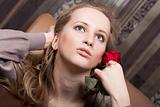 Beautiful young lady with a red rose