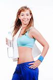 young woman in sports outfit holding a bottle of water smiling - islotad on white