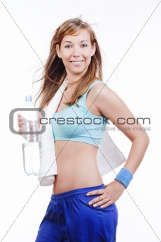 young woman in sports outfit holding a bottle of water smiling - islotad on white