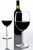 two wineglasses with red wine and bottle