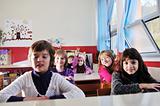 happy kids with  teacher in  school classroom