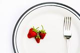 Strawberries and fork on a plate