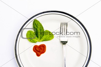 Spinach leaves and a fork on a plate