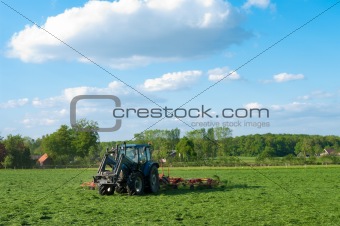 farmer mowing grass