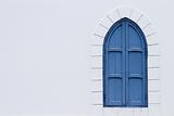 blue shutter window in white wall