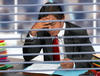 Businessman Reading Documents At His Desk