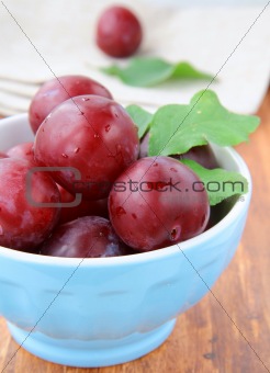 ripe, fresh red plums on the table