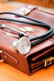 Doctor's case with stethoscope against wooden background 
