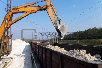 excavator loads gravel