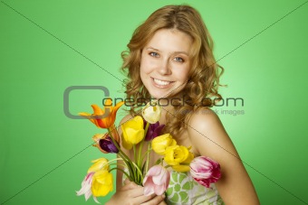 Happy Young Woman hugging a bouquet of tulips