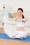 Beautiful female doing yoga on a gym carpet