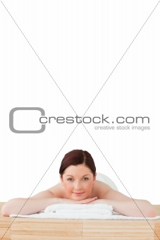 Charming red-haired woman relaxing in a spa centre