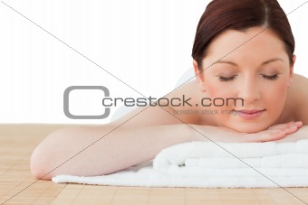 Cute red-haired woman relaxing in a spa centre