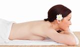 Portrait of a cute serene woman posing while relaxing in a spa c