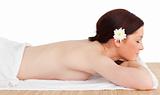 Portrait of a pretty serene woman posing while relaxing in a spa