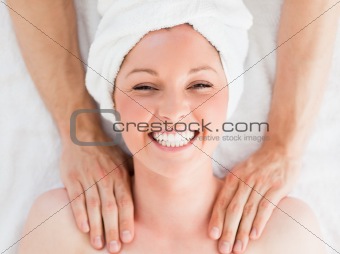 Closeup of a charming red-haired woman receiving a massage in a 