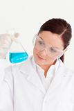 Attractive scientist holding a beaker in a laboratory