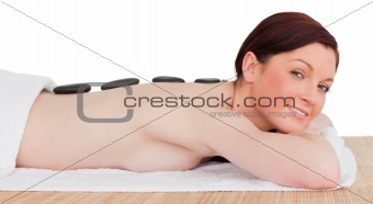 Portrait of a good looking red-haired woman posing while relaxin