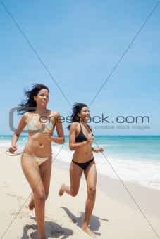 latina sisters in bikini on beach near caribbean sea