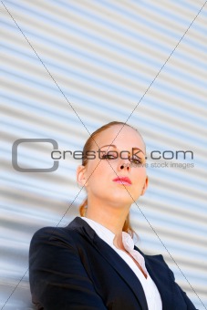 Proud business woman standing at office building
