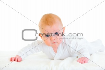 Cute  four month old  baby laying on abdomen on diaper
