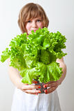 Young woman holding lettuce