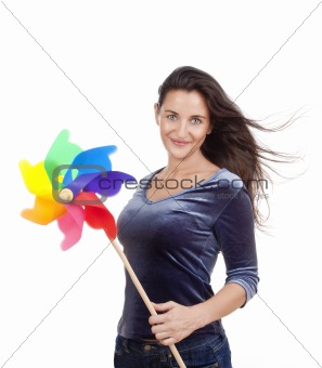 beautiful young woman holding a multicolored pinwheel - isolated on white 