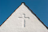 White cross on gable sky blue
