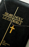 A golden cross on the top of  the bible