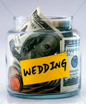 A lot of money in a glass bottle labeled “Wedding”