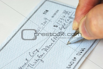 Writing a check to pay for the bill