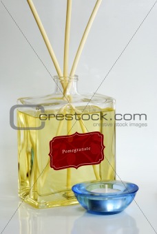 Fragrance oil with scented diffuser and a blue candle holder