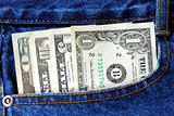 American money is in the pocket of blue jeans