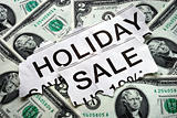 Holiday on sale signs with some $2 dollar bills