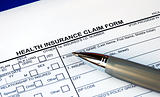Filling the health insurance claim form isolated in blue
