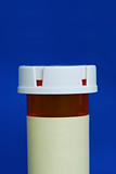 Medicine bottle with yellow label isolated on blue background.