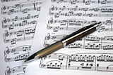 A pen on the top of music sheets