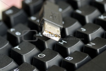 An USB connector on the black keyboard